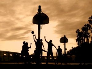 People Playing Basketball at Sunset