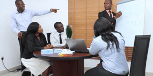 Group of People In a Meeting Writing on a White Board